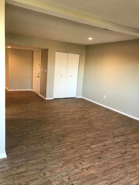 empty room with hardwood floors and a door at The Lakeside Village